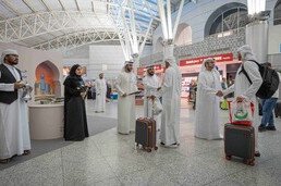 Returning Hajj pilgrims receive a warm welcome at Sharjah Airport with flowers and traditional Emirati hospitality